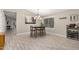 Light-filled dining room with a modern chandelier, seating for four and a convenient wine rack at 1583 N Constellation Ct, Gilbert, AZ 85234