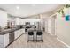 Modern kitchen with stainless steel appliances, center island with bar stool seating and white cabinetry at 1583 N Constellation Ct, Gilbert, AZ 85234