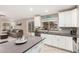 Modern kitchen featuring white cabinetry, gray countertops, and eat-in island, perfect for Gathering gatherings and entertaining at 1583 N Constellation Ct, Gilbert, AZ 85234