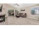 Bright living room featuring neutral paint, tile floors, and a sliding door to the backyard at 1583 N Constellation Ct, Gilbert, AZ 85234