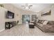 Inviting living room featuring neutral paint, tile floors, and a sliding door to the backyard at 1583 N Constellation Ct, Gilbert, AZ 85234