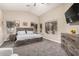 Spacious primary bedroom with an ensuite bath and large windows overlooking the backyard with a ceiling fan at 1583 N Constellation Ct, Gilbert, AZ 85234