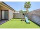 A backyard featuring a well-maintained green lawn and a playground with a slide and swings at 1616 N 125Th Ln, Avondale, AZ 85392