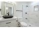 Contemporary bathroom featuring a vessel sink, modern fixtures, and a marble tiled shower at 1616 N 125Th Ln, Avondale, AZ 85392