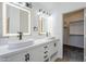 Elegant bathroom featuring double sinks, contemporary lighting, and a stylish vanity at 1616 N 125Th Ln, Avondale, AZ 85392
