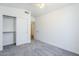 Bright bedroom featuring neutral carpet, and a large closet with sliding doors at 1616 N 125Th Ln, Avondale, AZ 85392