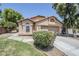 Charming single-story home featuring a well-manicured lawn and a two-car garage at 1616 N 125Th Ln, Avondale, AZ 85392