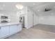 Open-concept kitchen with stainless steel appliances, white cabinets, and an island at 1616 N 125Th Ln, Avondale, AZ 85392