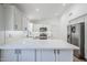 Bright kitchen featuring white cabinets, stainless steel appliances, and spacious quartz countertops at 1616 N 125Th Ln, Avondale, AZ 85392