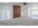 Bright living room featuring new plush carpet, a modern fan, and patio access at 1616 N 125Th Ln, Avondale, AZ 85392
