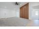 Spacious living room featuring a contemporary wood slat wall accent and neutral decor at 1616 N 125Th Ln, Avondale, AZ 85392