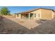 Home's backyard with a covered patio, privacy wall, and ample space for landscaping and outdoor activities at 18108 W Cassia Way, Goodyear, AZ 85338