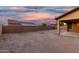 Expansive backyard with block wall fencing offering room for personalization with beautiful sky at 18108 W Cassia Way, Goodyear, AZ 85338