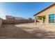 Home's backyard with a covered patio and privacy wall at 18108 W Cassia Way, Goodyear, AZ 85338