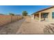 Spacious backyard featuring a covered patio and a high privacy wall, creating a secluded outdoor space at 18108 W Cassia Way, Goodyear, AZ 85338