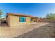 Home's backyard with a covered patio, privacy wall, and ample space for landscaping and outdoor activities at 18108 W Cassia Way, Goodyear, AZ 85338