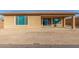 Backyard showcasing privacy wall and a patio with sliding glass door at 18108 W Cassia Way, Goodyear, AZ 85338