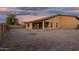 Expansive backyard featuring a covered patio and privacy wall, perfect for outdoor entertaining and relaxation at 18108 W Cassia Way, Goodyear, AZ 85338