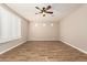 Spacious bedroom featuring neutral walls, a ceiling fan, and a large window for natural light at 18108 W Cassia Way, Goodyear, AZ 85338
