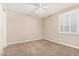 Clean bedroom with neutral walls, carpet flooring, and plantation shutters at 18108 W Cassia Way, Goodyear, AZ 85338