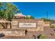 View of the Presidio Residents Club community sign on a clear, sunny day at 18108 W Cassia Way, Goodyear, AZ 85338