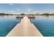 Picturesque view from a community dock with seating overlooking a serene lake and mountains at 18108 W Cassia Way, Goodyear, AZ 85338