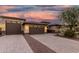Lovely home with a three-car garage, block-paved driveway, and mature desert landscaping at 18108 W Cassia Way, Goodyear, AZ 85338
