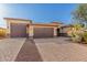 Charming home featuring a three-car garage and well-maintained desert landscaping at 18108 W Cassia Way, Goodyear, AZ 85338