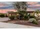 Beautifully landscaped front yard featuring a mature tree and desert foliage, enhancing curb appeal at 18108 W Cassia Way, Goodyear, AZ 85338