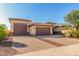 Lovely home with a three-car garage, block-paved driveway, and mature desert landscaping at 18108 W Cassia Way, Goodyear, AZ 85338