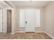 Bright foyer with wood-look tile floors and modern front door and sidelight shutters at 18108 W Cassia Way, Goodyear, AZ 85338