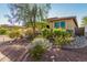 Landscaped front yard with colorful plants and trees adds to the home's curb appeal at 18108 W Cassia Way, Goodyear, AZ 85338