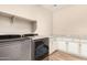 Well-equipped laundry room with modern appliances, cabinetry, and granite countertops at 18108 W Cassia Way, Goodyear, AZ 85338