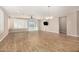 Spacious living room with wood-look tile, ceiling fan and sliding glass doors at 18108 W Cassia Way, Goodyear, AZ 85338