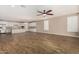 Spacious living room featuring wood-look tile flooring and a ceiling fan, perfect for relaxing or entertaining at 18108 W Cassia Way, Goodyear, AZ 85338