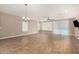 Large, bright living room with tile floors, ceiling fan, and sliding glass door to backyard at 18108 W Cassia Way, Goodyear, AZ 85338