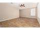 Inviting living room with tile flooring, a ceiling fan, and plenty of natural light at 18108 W Cassia Way, Goodyear, AZ 85338