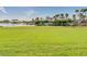 Expansive community pool area with palm trees, lush landscaping, and water slide at 18108 W Cassia Way, Goodyear, AZ 85338