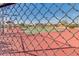 A peek through the fence at immaculately kept tennis courts in a well maintained park setting at 18108 W Cassia Way, Goodyear, AZ 85338