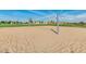 Sandy volleyball court with net set up in a well maintained community park, ready for a game at 18108 W Cassia Way, Goodyear, AZ 85338