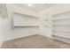 Spacious walk-in closet with shelves, hanging rods, and carpeted floor at 18108 W Cassia Way, Goodyear, AZ 85338