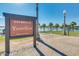View of the Estrella Yacht Club featuring palm trees, lake access, and manicured lawns at 18108 W Cassia Way, Goodyear, AZ 85338