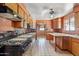 Functional kitchen space with wood cabinets, tile countertops, and adjoining dining area at 2020 W Marshall Ave, Phoenix, AZ 85015