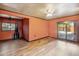 Bright living room with laminate floors, ceiling fan, and sliding glass doors at 2020 W Marshall Ave, Phoenix, AZ 85015