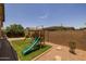 Large backyard featuring a playground and ample space for outdoor activities and entertainment at 20904 E Swan Dr, Queen Creek, AZ 85142