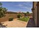 Spacious backyard with lush grass, brick pavers, playground set and brick wall for privacy at 20904 E Swan Dr, Queen Creek, AZ 85142
