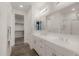 Bathroom features double sinks, white cabinets, a large mirror, and a walk-in closet at 20904 E Swan Dr, Queen Creek, AZ 85142