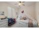 Charming bedroom with a decorative bed, playful wallpaper and a bright window at 20904 E Swan Dr, Queen Creek, AZ 85142