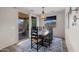 The dining room has a wooden table, black chairs, and sliding doors to the backyard patio at 20904 E Swan Dr, Queen Creek, AZ 85142