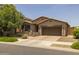 Inviting single-story home with lush front lawn and landscaping, paired with a spacious two-car garage for modern suburban living at 20904 E Swan Dr, Queen Creek, AZ 85142